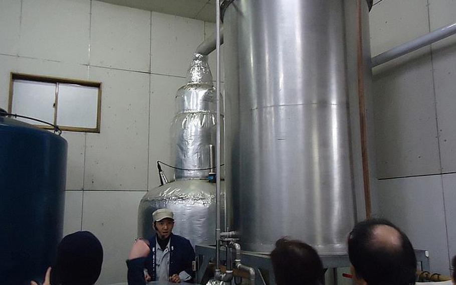 A tour guide shows off shochu tanks at Sasebo's Umegae sake brewery during a tour on Feb. 9. Umegae brews wheat shochu and fruit-flavored alcohols during May and June and potato shochu during October and November. Shochu is a harder liquor than nihonshu, which is often referred to as "sake" by Americans. "Sake" merely means alcohol in Japanese. Shochu is very popular in Kyushu.