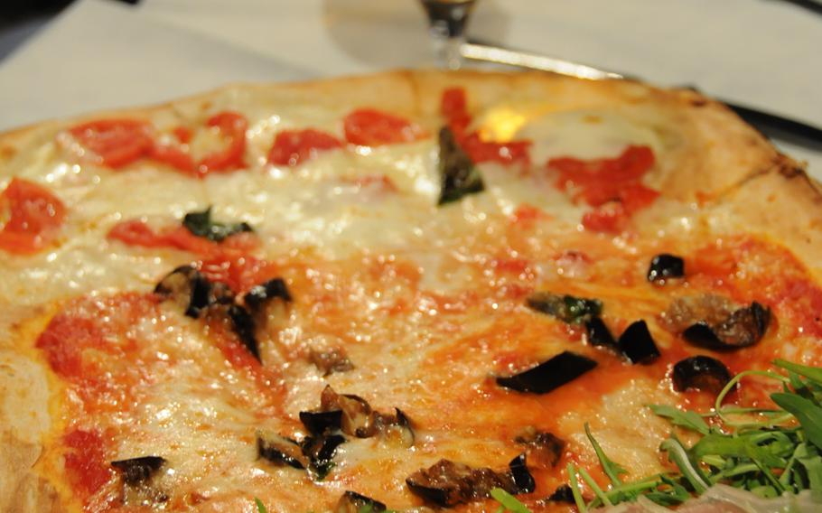 Pizza by the meter is the specialty of Il Tucano restaurant and pizzeria in the beach town of Baia, a suburb of Naples. Pictured here, a half-meter, three-flavored pizza -- perfect for splitting between two diners.