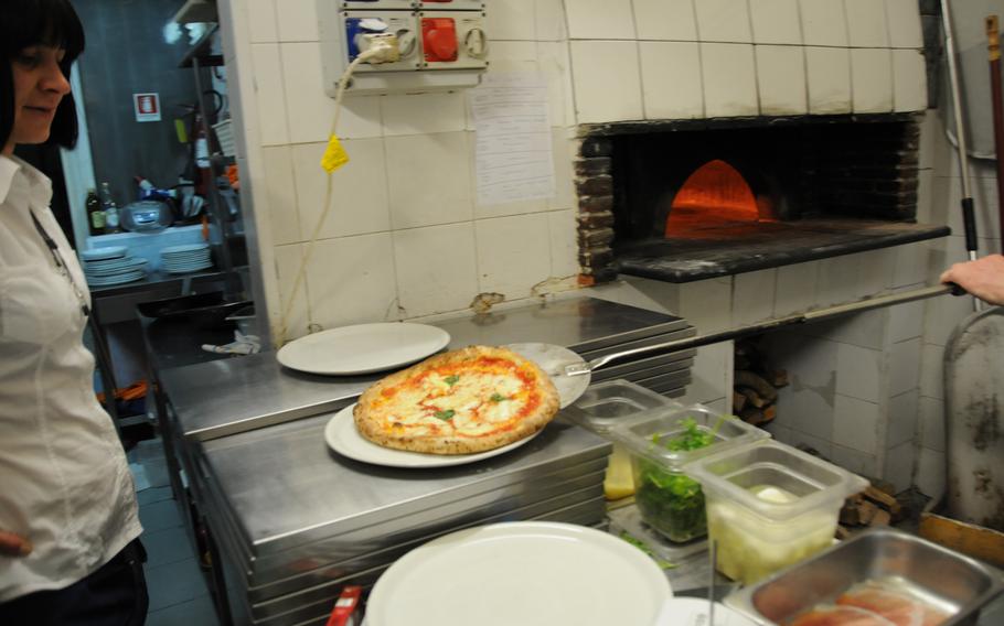 "Voila!" (OK, we know that's French). After just a few minutes in a piping-hot, wood-fueled brick oven, out comes a scrumptious Pizza Margherita -- perhaps the most popular and topped only with mozzarella cheese, tomato sauce and fresh basil.