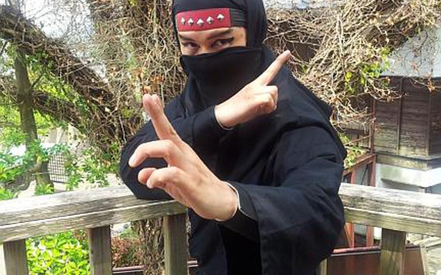 A ninja at Hizen Yume Kaido, also known as ninja village, in Ureshino, Japan, strikes a pose after luring another ninja into a trap house where he was defeated. 