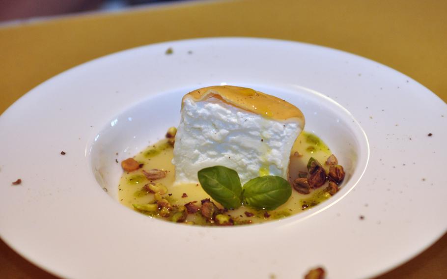 A small round of smoked cheese surrounded by a potato puree with pistachios and basil served as an appetizer during a recent visit to Osteria Antico Burchiello in Pordenone, Italy.