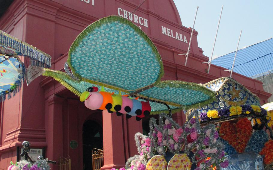 Rickshaws festooned in brightly-colored tinsel and flowers wait for customers outside Melaka's Christ Church, built in the 1700s by the Dutch and now a popular tourist site. The city was heavily influenced by Chinese, Indian and European immigrants and is considered a melting pot of cultures.