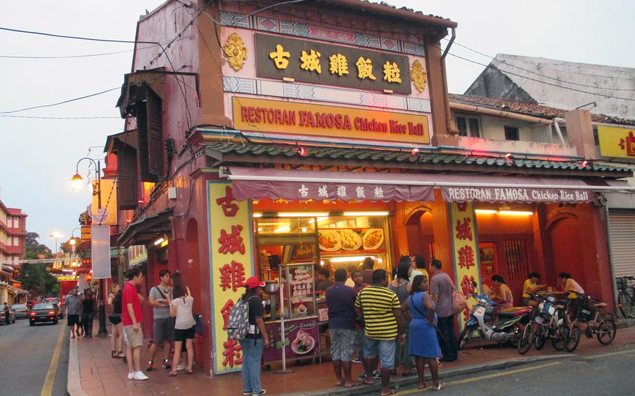 Customers wait in line outside a popular Jonker Street eatery, one of many restaurants in a city known for its European- and Asian-influenced cuisine.