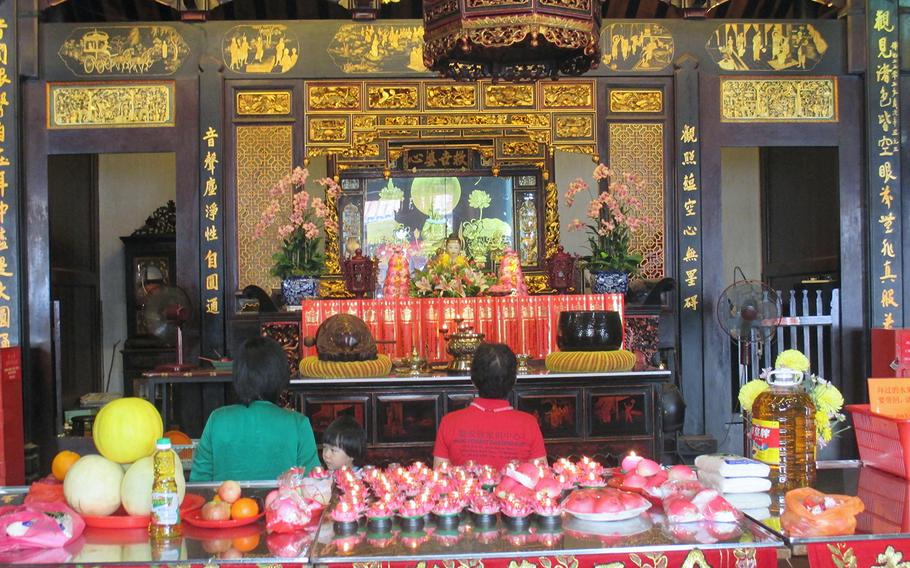 Worshipers pray inside the Cheng Hoon Teng, or Green Clouds, Temple in Melaka, built in  the 1600s.
