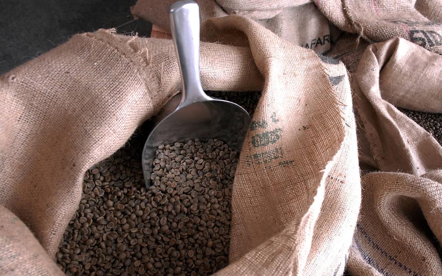 Burlap sacks full of green coffee beans sit in the back room of Kaffeerösterei Kaiserslautern, a new coffee shop in Kaiserslautern, Germany. Cafe owners Christian and Stephanie Bebensee roast their own beans. They use the beans in the coffee drinks they sell and also sell the beans in varying quantities to individuals and commercial businesses.