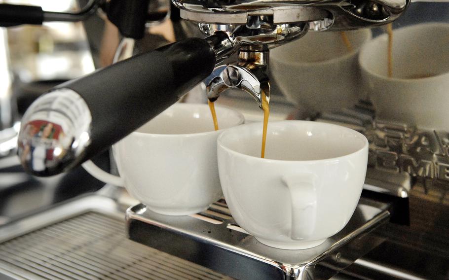 Light brown espresso streams into two cups at Kaffeerösterei Kaiserslautern   