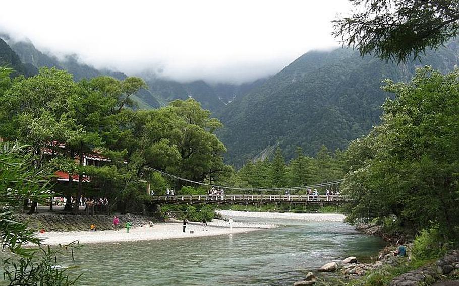 Visitors walk along the Kappabashi bridge in Kamikochi. Fortunately for those looking for a little time away from the crowds, most tourists don't venture much beyond the bridge.