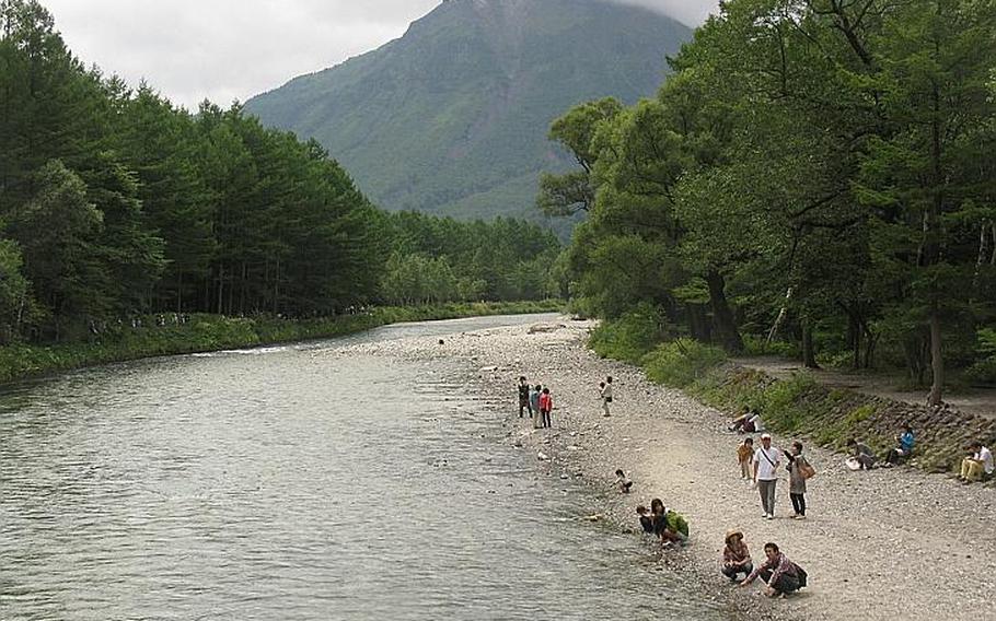 Visitors line the banks of the Azusa River in Kamikochi.