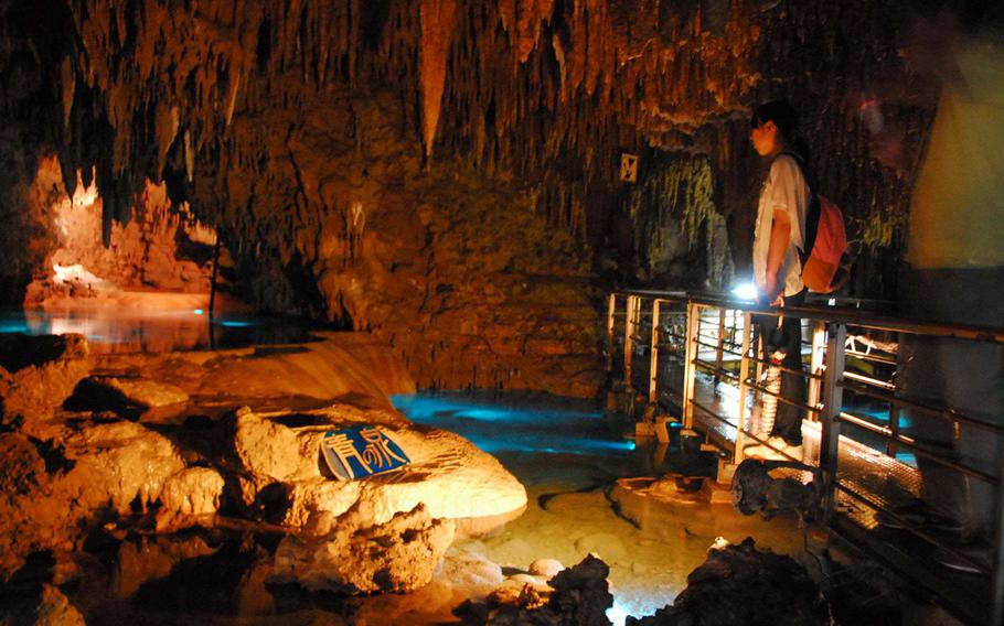 A cave chamber with pools of water.