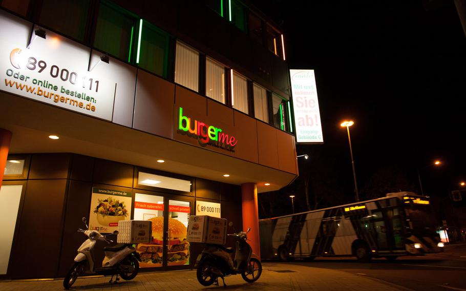Burgerme scooters sit outside the chain's store in Kaiserslautern waiting to transport hot beef to customers.