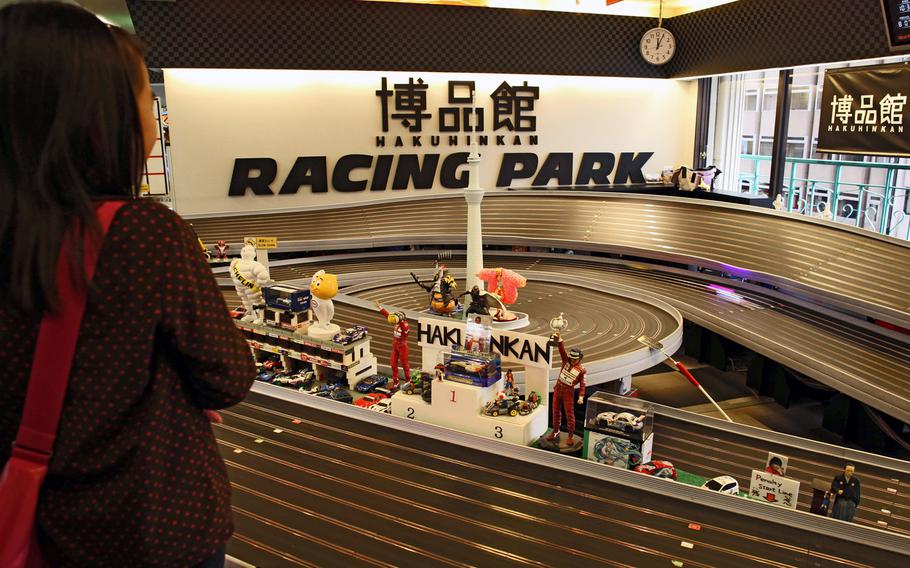 Slot cars zip by on the slot car track on the fourth floor of Ginza's Hakuhinkan Toy Park.