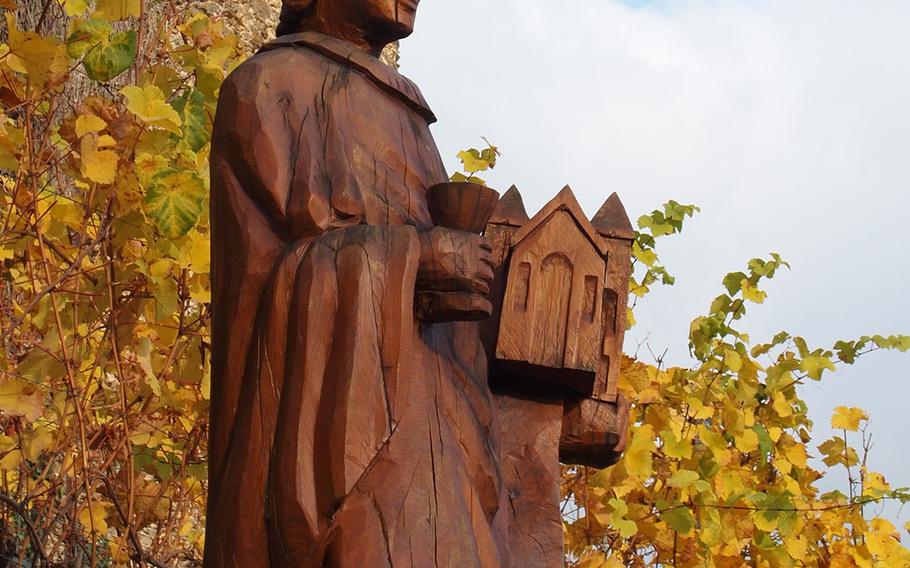 Saint Goar, the patron saint of innkeepers, potters and vine growers, stands watch over colorful vineyards at the foot of Burg Rheinfels high above the village that's named in honor of him in Germany.