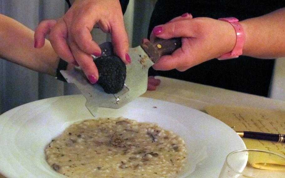 Our server, Marianna Gasparini, a longtime employee of  Antica Trattoria Moreieta, shaves the black truffle over my risotto.