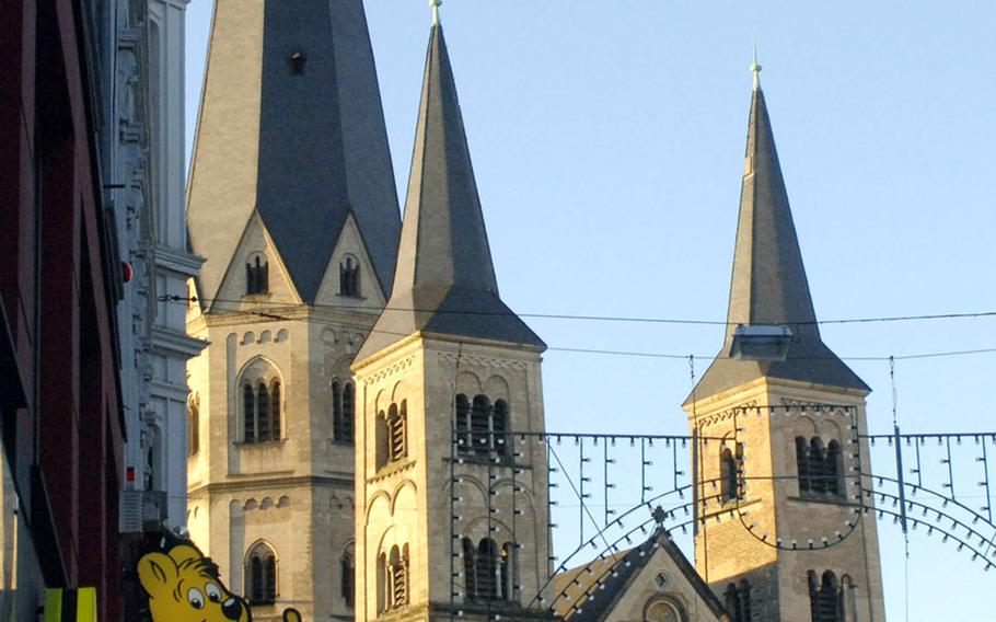 The 11th-century cathedral Bonn Minster stands in the background of the Haribo store in Bonn, Germany.