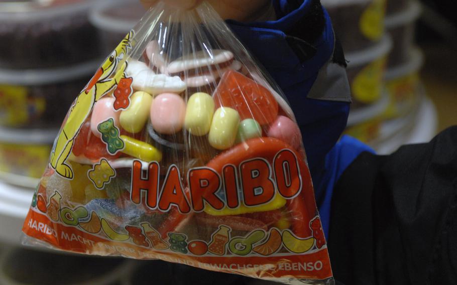 A customer holds a bag of assorted candies at the Haribo store in Bonn, Germany, on Friday, Dec. 20, 2013.