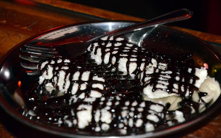 A delicious coconut dessert drizzled in chocolate syrup completes a fine meal at New Punjab, an Indian restaurant in Fontanafredda, Italy.