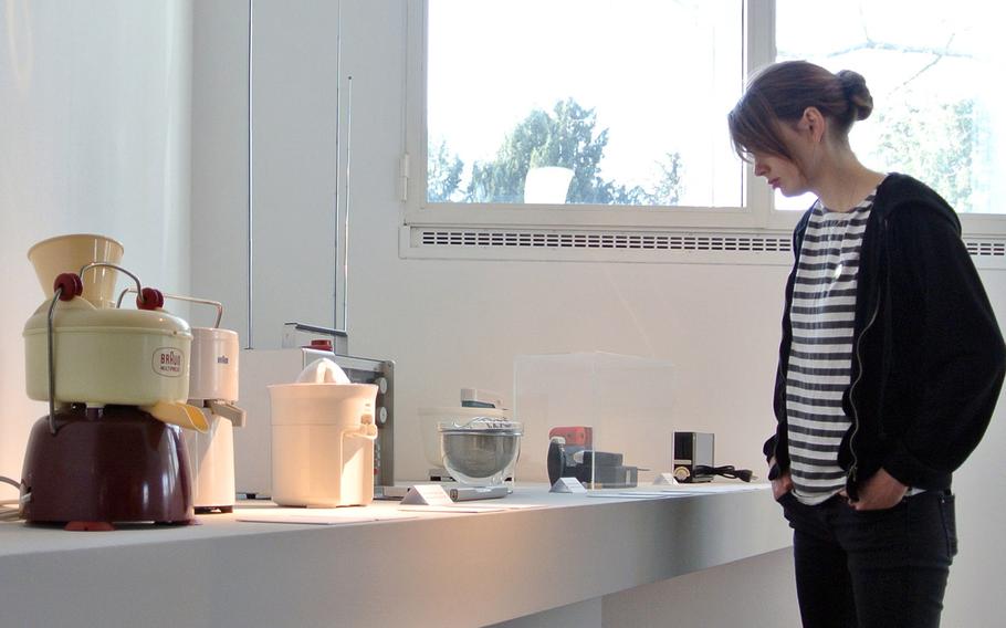 A visitor to Frankfurt's Museum Angewandte Kunst, or Applied Arts Museum, checks out appliances designed by Braun, a German electronics manufacturer.