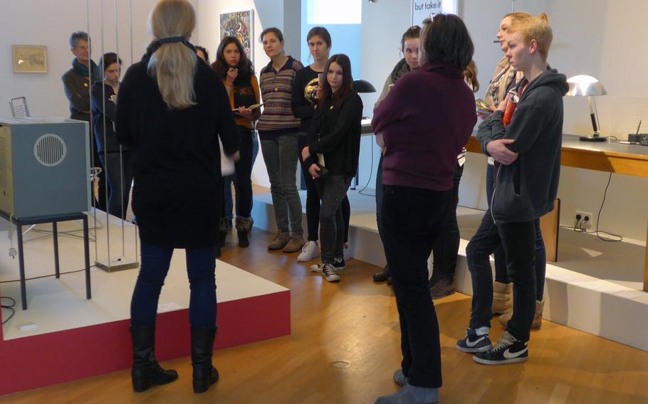 A school class tours the "Frankfurt Room" at the Museum Angewandte Kunst, or Applied Arts Museum, in Frankfurt. The room features objects designed in Frankfurt.