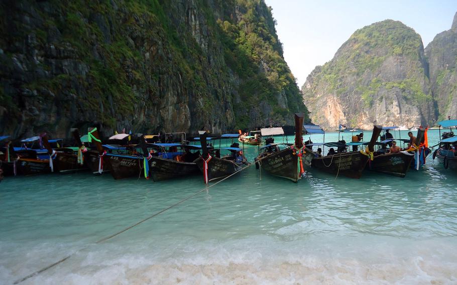 Thai water taxis park at Phi Phi Leh's beach at Maya Bay, site where "The Beach" starring Leonardo DiCaprio was filmed.