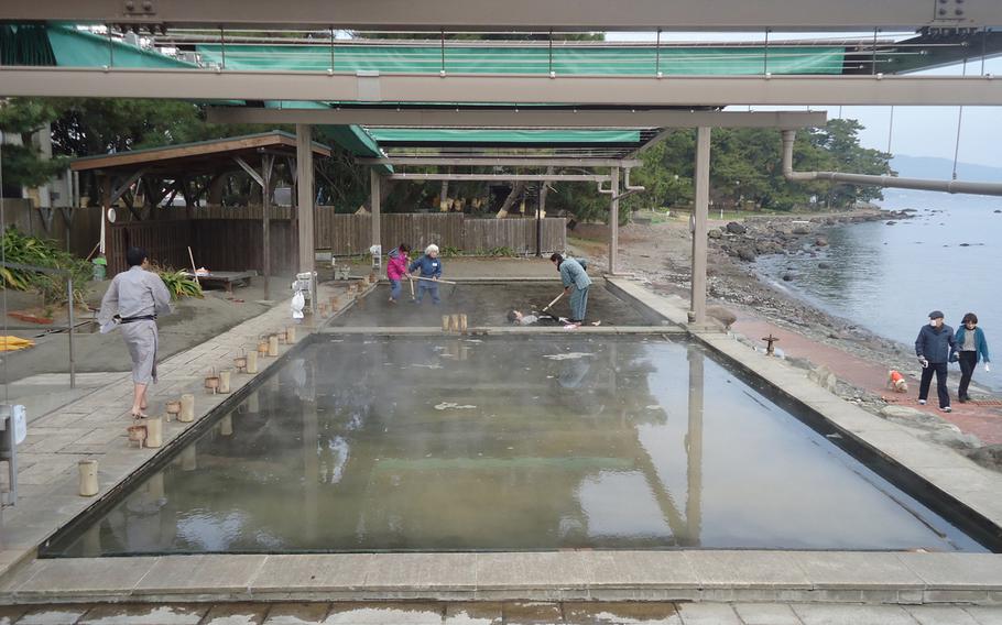 Patrons at Beppu Kaihin Sunayu get buried in the beach sand in the background, while sand is soaked in hot-spring water in the foreground. They the spa alternates which sand box is used, ensuring that the sand is always clean and piping hot.