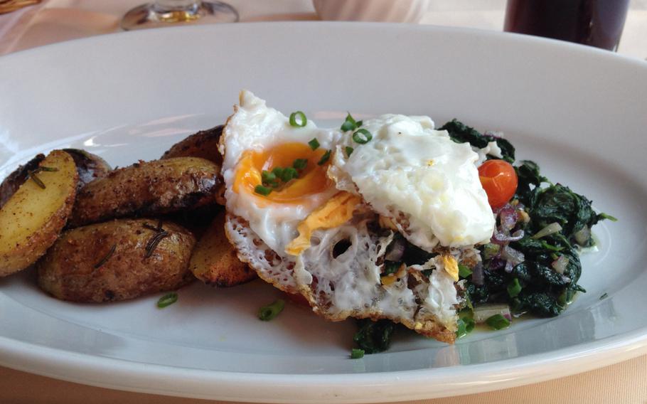 Sauteed spinach with rosemary potatoes topped with a fried egg, as served by Wiesbaden, Germany's, Beef 'n Reef restaurant.