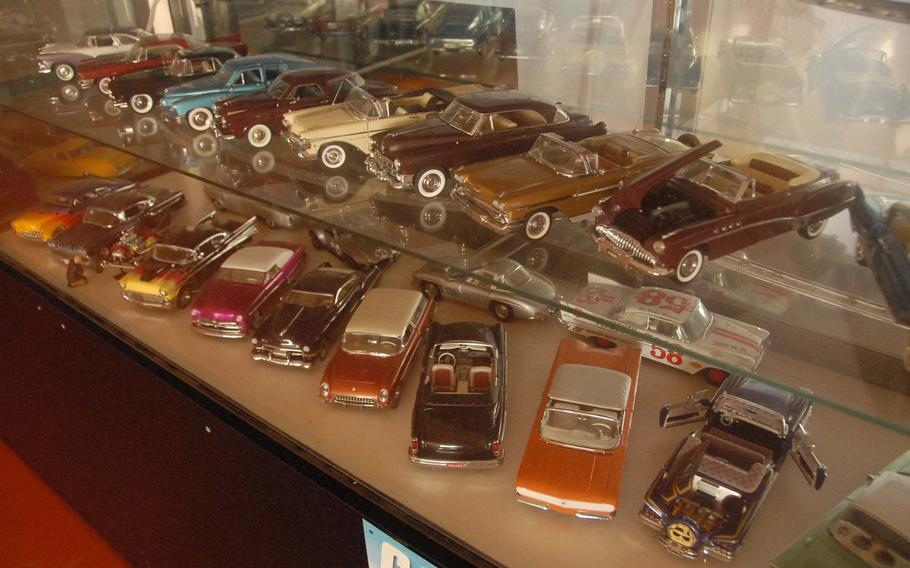 Two glass cases of model vintage cars are on display at the Seaside Drive-In on Okinawa.