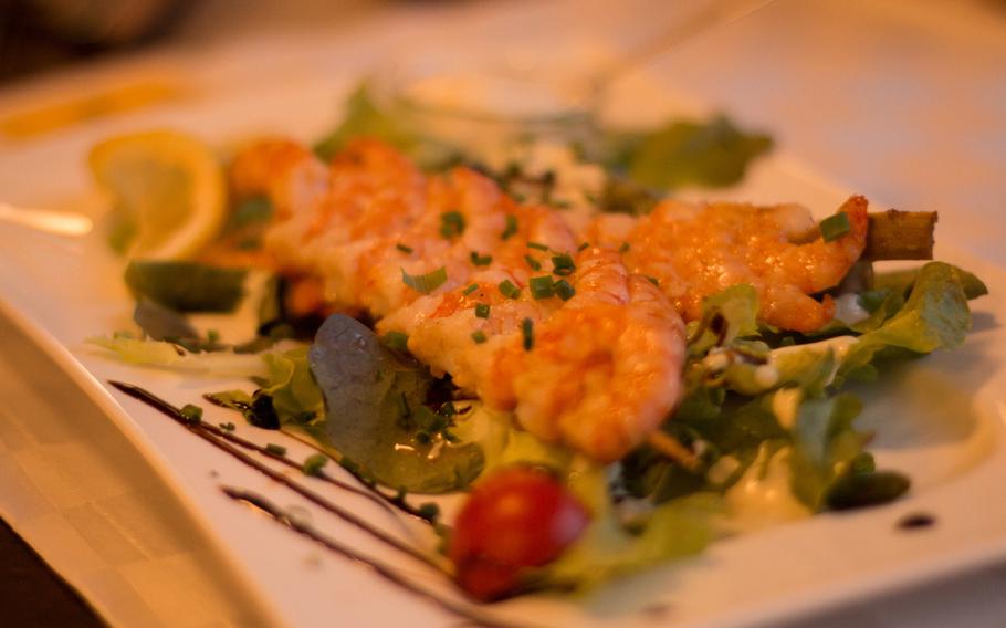 The scampi shrimp skewers atop a fresh salad is one of the lighter items on the menu at Rossini Restaurant and Eiscafe in Amberg, Germany.