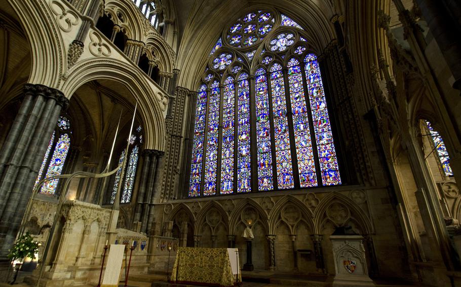 A stained glass window overlooks an altar at the eastern end of Lincoln Cathedral.