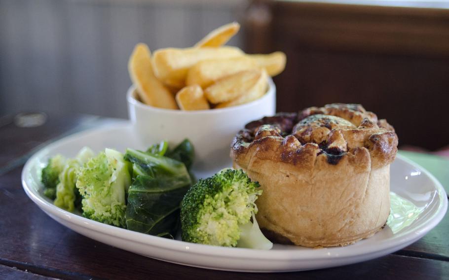 The braised-beef pie at The Architect restaurant in Cambridge, England, comes with thick-cut chips on the side.  The Architect offers pub classic entrees and meats from a spit.