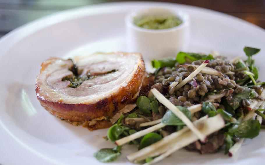 The pork belly at The Architect restaurant in Cambridge, England comes with a mix of greens, lentils, apple and bacon. The restaurant also offers lamb and steak.