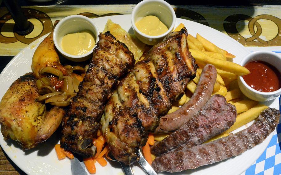 A half of a chicken, spare ribs and a few mixed sausages make up a dish designed for two at Bierengel, a Bavarian restaurant in Cordenons, Italy. The hefty platter comes with a fair price of 29.50 euros.