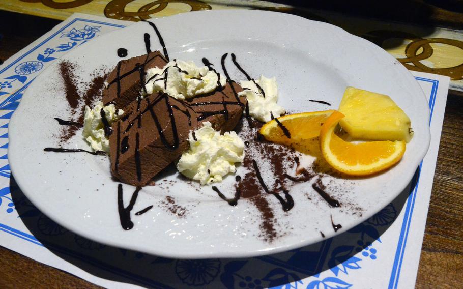A Bavarian chocolate cake is one of many desserts offered at Bierengel, a Bavarian restaurant in Cordenons, Italy. The chocolate cake, drizzled with fudge and topped with whipped cream, costs 4.90 euros.