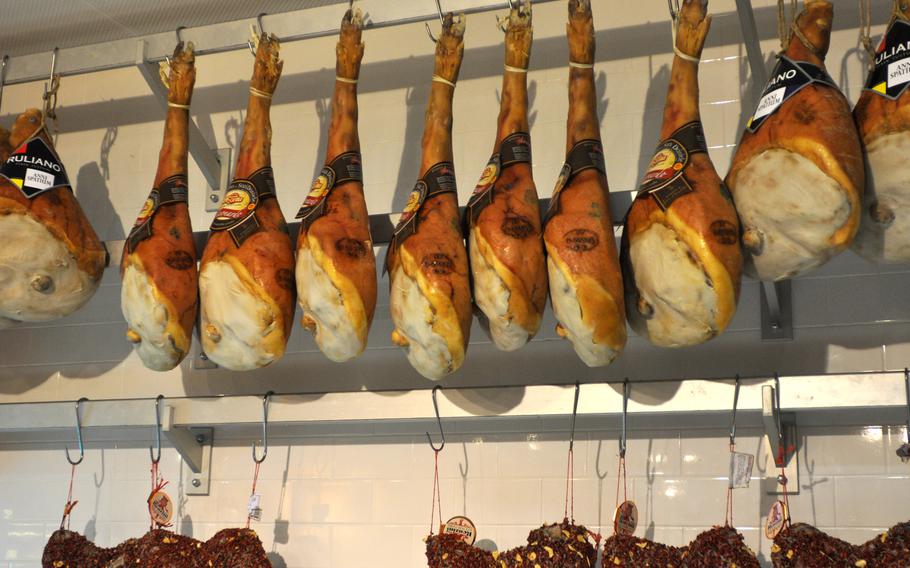 Cheese isn't all that's offered at the cheese shop of Percosi Enogastronomici di Ricerca. Hanging prosciutto forms one wall of the store. Pasta, various sauces and numerous other food products are also sold.