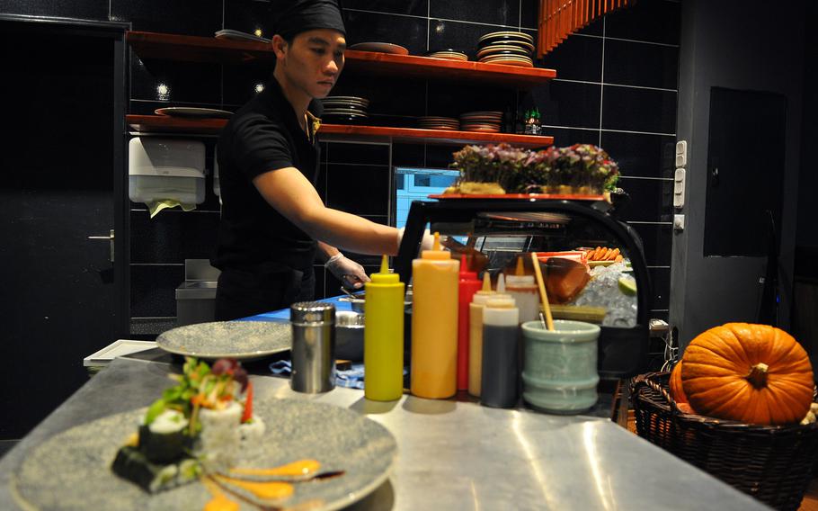 A sushi chef works out in the open at Mr. Lian.