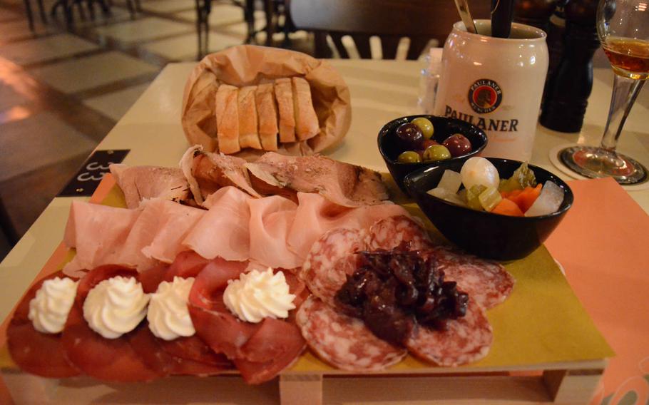The Gammon music pub near Aviano Air Base, Italy, serves cold meat trays for 12 euros. Here, peppered and salted porchetta, Prague ham, and salami is accompanied by bresaola and fresh cheese, pickled vegetables, olives and stewed onions.