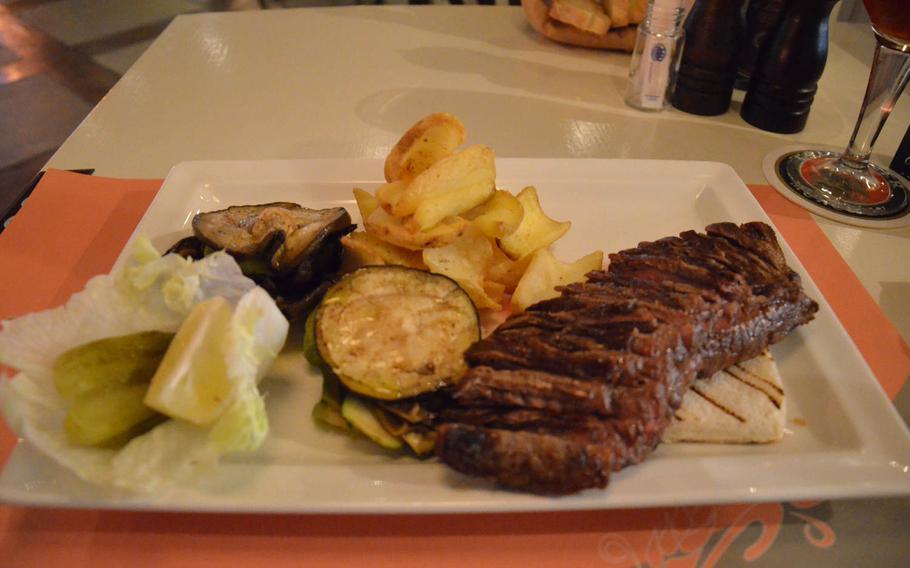 The Gammon music pub near Aviano Air Base, Italy, offers an array of steaks to choose from, but owner Alessandro Del Ben says the 10.5 ounce Black Angus beef steak, shown here, is the pub's best. The steak costs 18 euros and is accompanied by crisp potatoes and grilled vegetables.