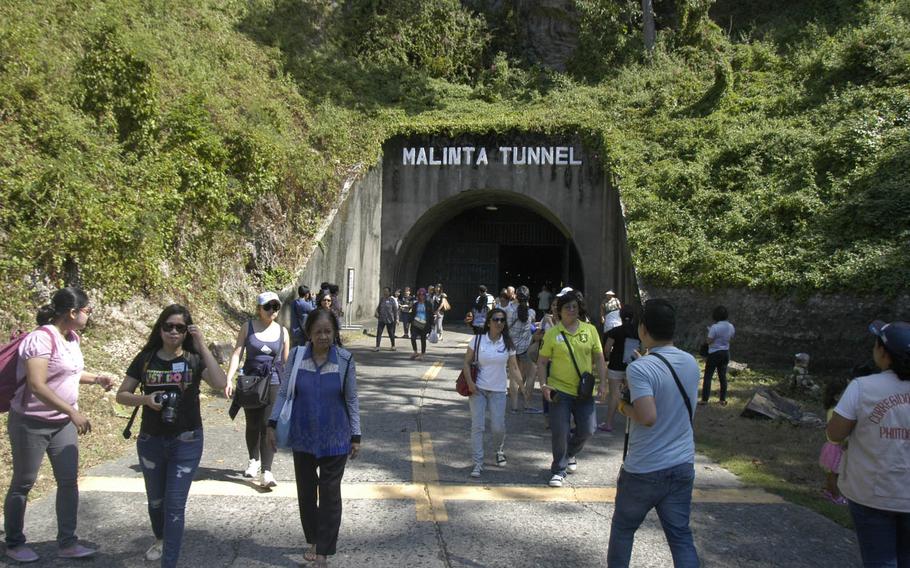 Tourists exit Malinta Tunnel on Corregidor Island in the Philippines. Philippines President Manuel L. Quezon, U.S. Gen. Douglas MacArthur and other high-ranking officials sheltered in the tunnel complex during a Japanese bombing campaign that reduced the surface of the island to barren rock.