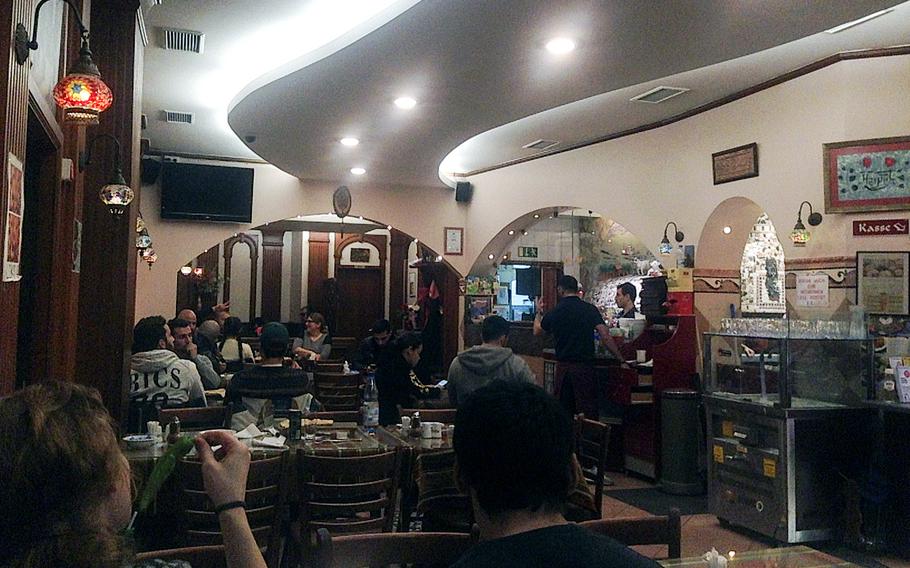 The interior of Harput Turkish Restaruant in Wiesbaden, Germany, including the kitchen area at right, which is in plain view of diners. The restaurant was busy even on a Tuesday night, and offers a takeaway service as well.