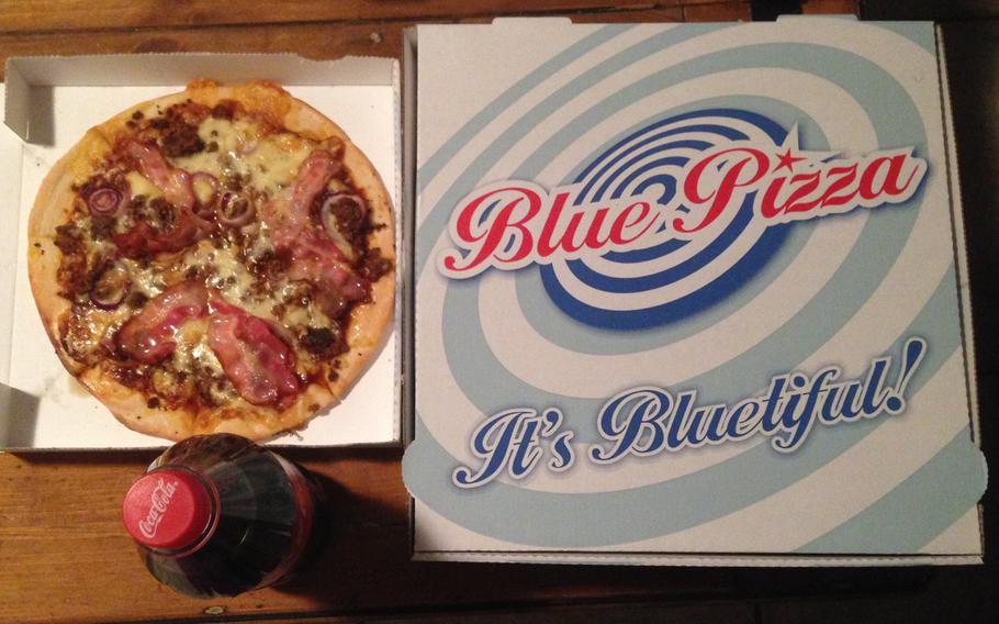 A small Texas pizza from Blue Pizza, a new pizza takeout in eastern Kaiserslautern, Germany. The Texas pizza is topped with red onions, bacon, ground beef and barbecue sauce.