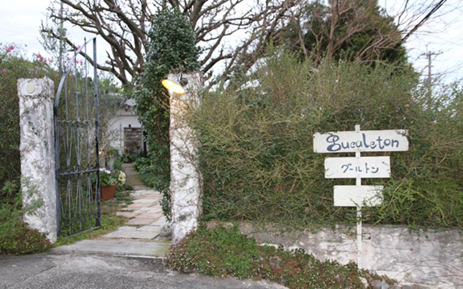 A simple sign in front of a hedgerow is the only marker that advertises Gueuleton, a fine-dining restaurant hidden away in Okinawa City.