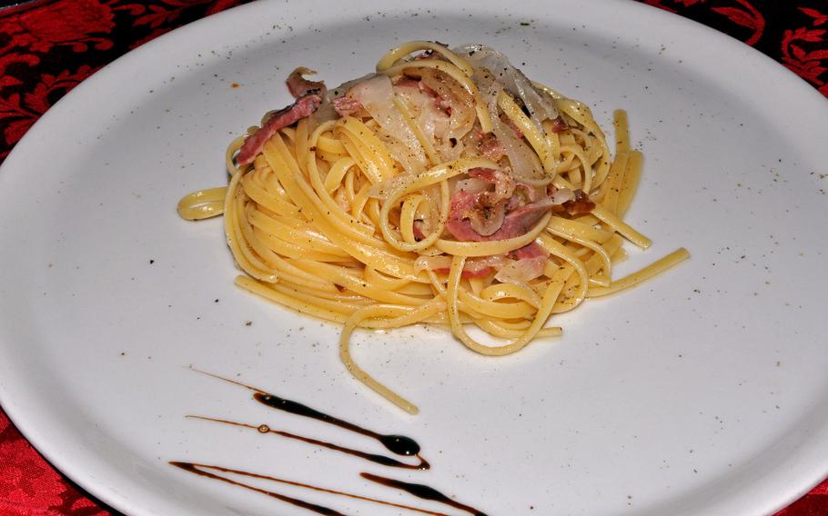 This pasta dish at Mama Fela in Vigonovo, Italy, features bacon, truffle oil and pepper.