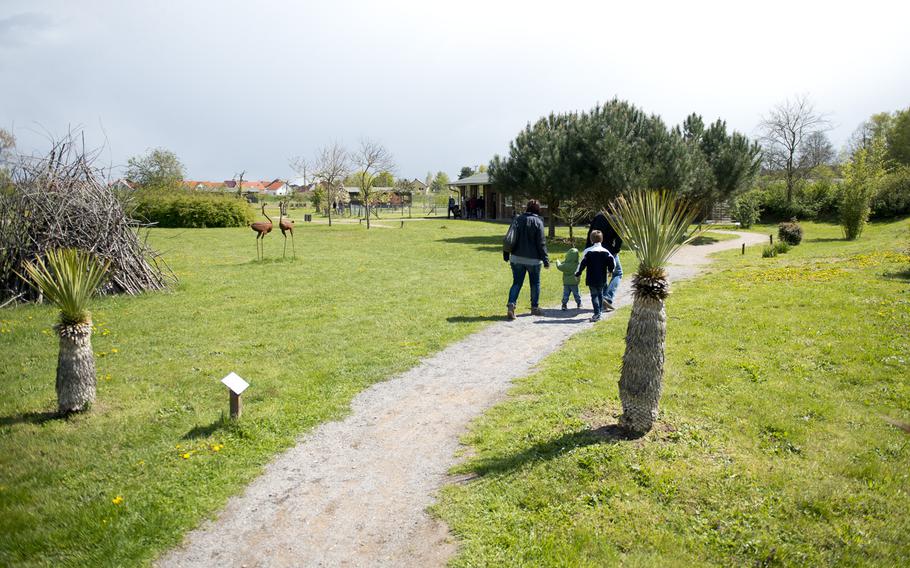 Visitors follow the walking trail at Ostrich Farm Mhou in Ruelzheim, Germany, April 24, 2016. The trail has over 50 species of trees and shrubs from several different countries.