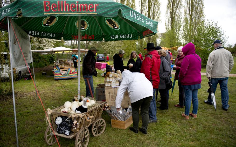 Visitors look at items for sale during the farmer's market at Ostrich Farm Mhou in Ruelzheim, Germany, April 24, 2016. The farm has monthly events from March to December.