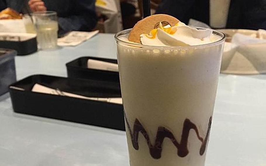 Cafe Blanket at the Snoopy Museum Tokyo serves "Peanuts"-inspired dishes, such as this mango milkshake complete with a jagged chocolate Charlie Brown stripe inside the glass.
