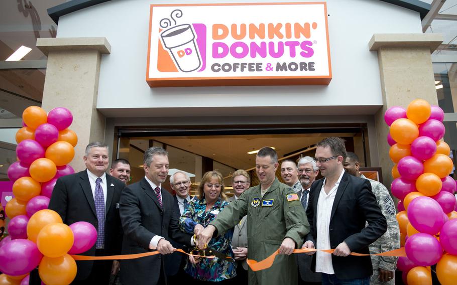 Representatives from U.S. Air Forces in Europe, the Army and Air Force Exchange Service and Dunkin' Donuts cut the ribbon at the grand opening of the Dunkin' Donuts store in the Kaiserslautern Military Community Center at Ramstein Air Base, Germany, on Thursday, June 16, 2016. This is the first Dunkin' Donuts at a U.S. military base in Europe.