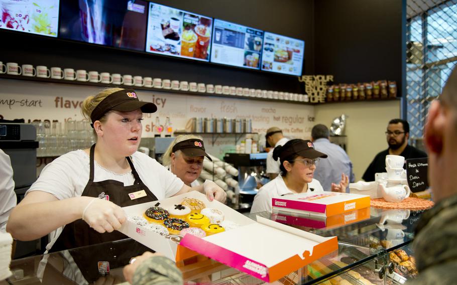 Workers prepare orders at the grand opening of the Dunkin' Donuts in the Kaiserslautern Military Community Center at Ramstein Air Base, Germany, on Thursday, June 16, 2016.