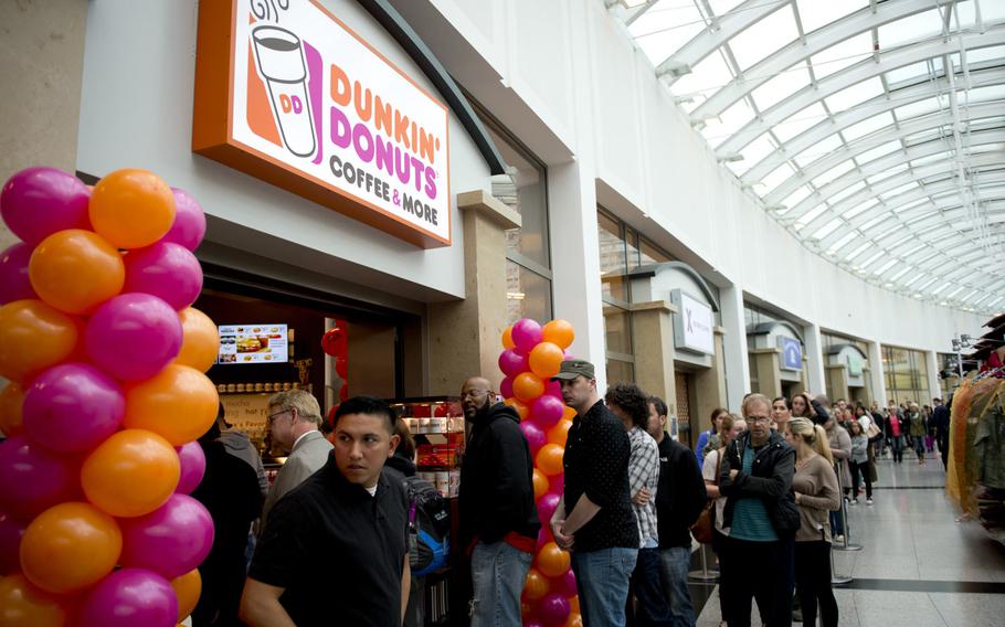 Customers wait in line at the grand opening of Dunkin' Donuts in the Kaiserslautern Military Community Center at Ramstein Air Base, Germany, on Thursday, June 16, 2016. The Ramstein store is the first Dunkin' Donuts at a U.S. military base in Europe.