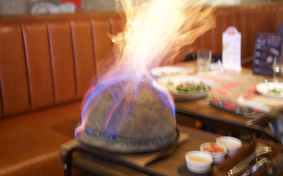 Flames engulf a "bomb pizza" at The Place, an Italian restaurant chain in Seoul. Waiters set the dough on fire at the table, then use scissors to cut off the top, revealing a piping hot pizza inside. The eatery also serves a variety of salads and other dishes.  