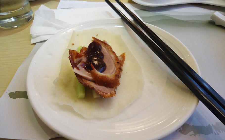 Sauce is added before Kings' Lodge's signature roast duck can be rolled up and eaten.