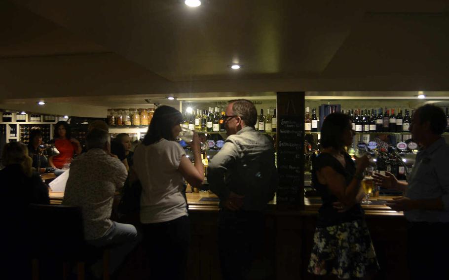 A typical Saturday night at The One Bull in Bury St. Edmunds, England. The rustic-chic restaurant offers a full bar, lounging areas with sofas and a dining area. 